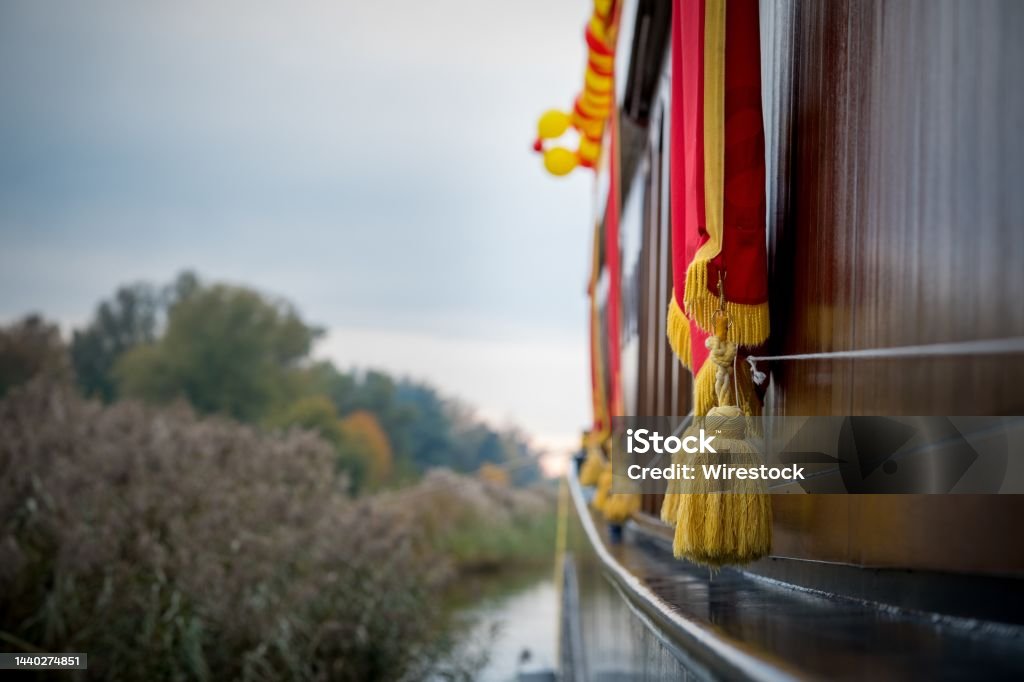 Closeup selective focus shot of golden tassels hanging over a boat in Elburg, Netherlands A closeup selective focus shot of golden tassels hanging over a boat in Elburg, Netherlands Architecture Stock Photo