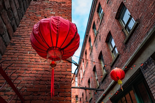 A low angle shot of Chinese lanterns in Fan Tan Alley, Chinatown, Victoria, BC Canada