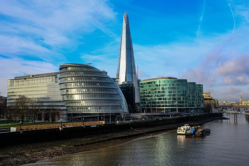 London, United Kingdom – February 05, 2019: The London Thames and the Shard behind City Hall against a blue sky