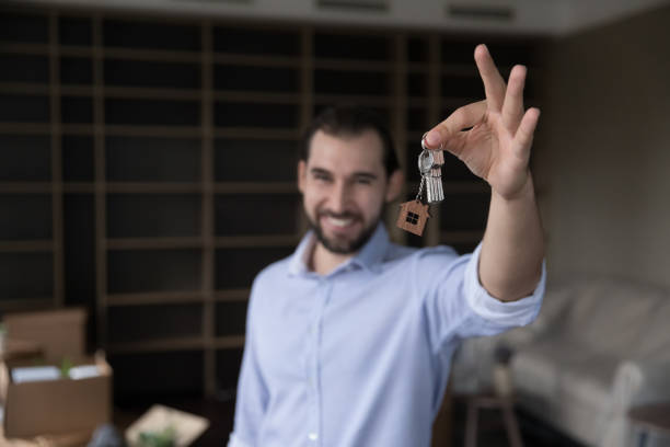 istock Overjoyed man showing bunch of keys on camera 1440276507