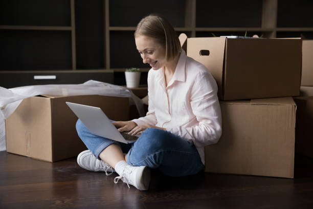 istock Woman using laptop make order, buying online on relocation day 1440276578