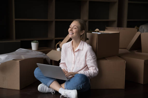istock Young attractive woman use laptop making order on relocation day 1440276638
