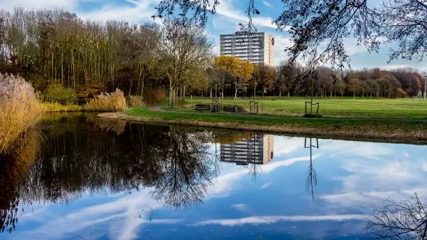 Apartment building reflections in the Madestein park in November in The Hague