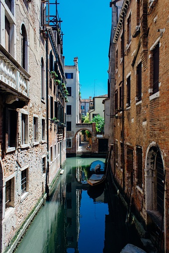 A beautiful shot of a canal in the middle of the historic city of Venice, Veneto, Italy