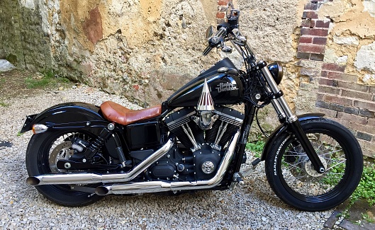 Paris, France – July 07, 2016: A vintage Harley Davidson Street Bob 1690cc motorbike parked on the street