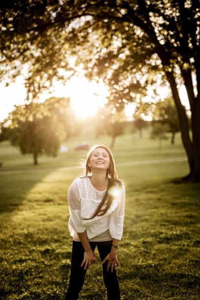 istock Vertical shot of a female laughing while looking at the camera with a blurred background 1440278718
