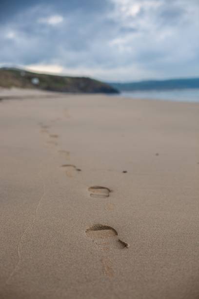 istock Vertical selective focus shot of a sandy beach under the clear sky in Cornwall, England 1440280924