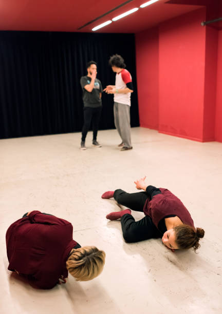 istock 4 theater students in class: two standing and two reclining 1440281734