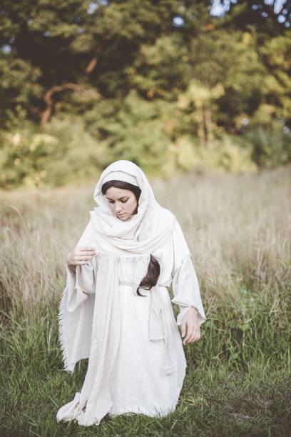 istock Vertical shot of a female down on her knees while wearing a biblical robe 1440282532