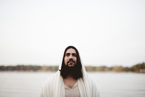 A shallow focus shot of the Jesus Christ looking towards the camera