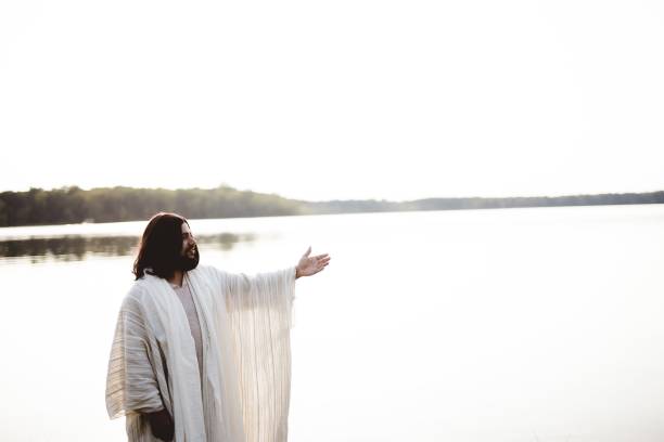 istock Jesus Christ standing near water while lending a helping hand 1440283772