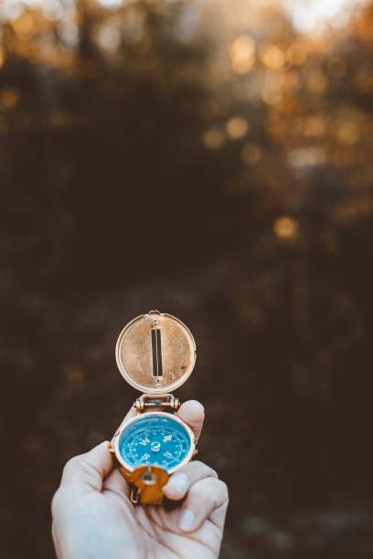 istock Vertical shot of a person holding a compas with a blurred background 1440284508