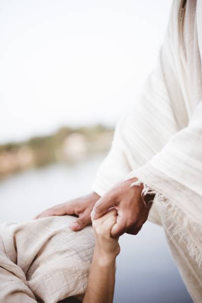 vertical shot of jesus christ healing the female with a blurred background - jesus cristo imagens e fotografias de stock