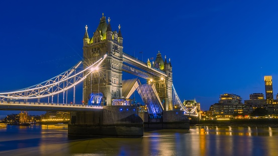 A beautiful shot of the famous Tower Bridge spreading light under the night sky in London