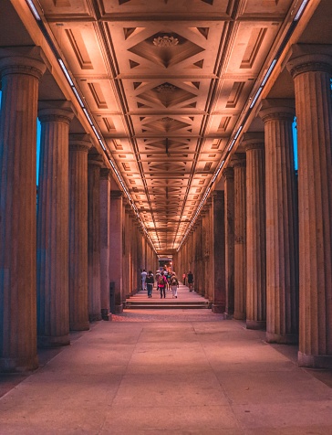 A vertical shot of the illuminated Brandenburg Gate in Berlin from the inside in the evening