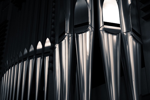 Close up of organ pipes from a church organ in a dark atmosphere
