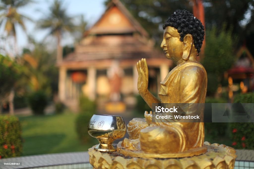 Closeup shot of a golden Buddha statue in a Thai temple in Malaysia. Great for religious scenarios A closeup shot of a golden Buddha statue in a Thai temple in Malaysia. Great for religious scenarios Ancient Stock Photo