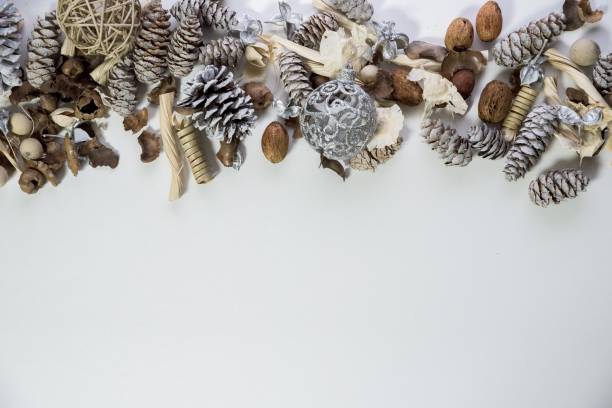 istock Overhead shot of pine cones and ornaments on a white surface great for writing text or background 1440288889