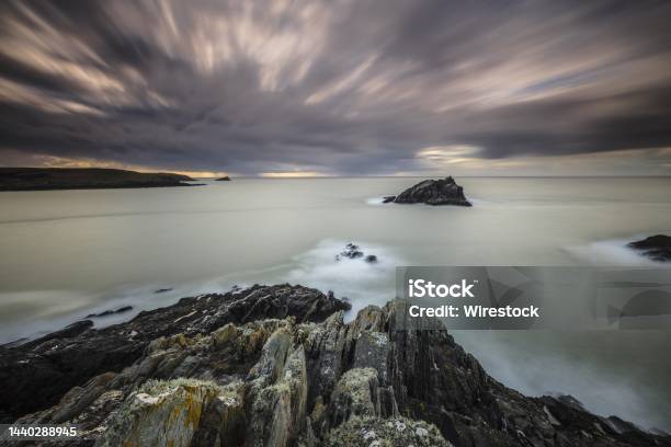 Gloomy Scenery Of The Calm Ocean Under The Dark Sky In Pentire Point East Cornwall Uk Stock Photo - Download Image Now