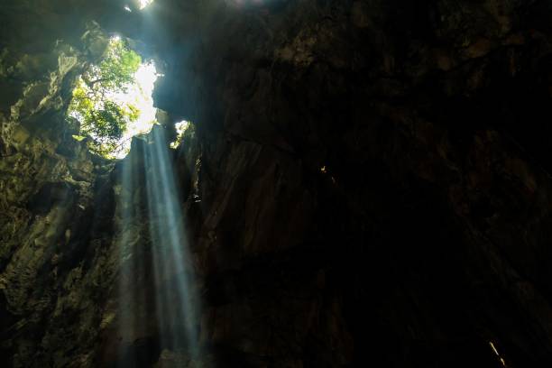 istock Breathtaking scenery of bright sun rays falling inside a cave illuminating the surroundings 1440289396