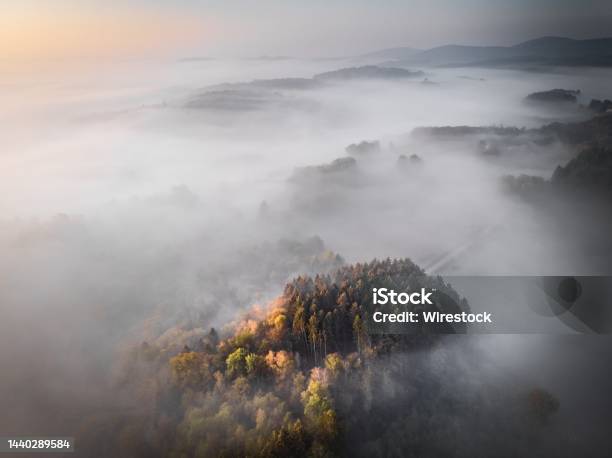 Aerial Shot Of A Forested Mountain Srouned By Fog Great Fora Background Or A Blog Stock Photo - Download Image Now