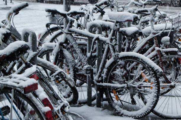 istock Sidewalk with bicycles parked near each other covered in snow 1440289642