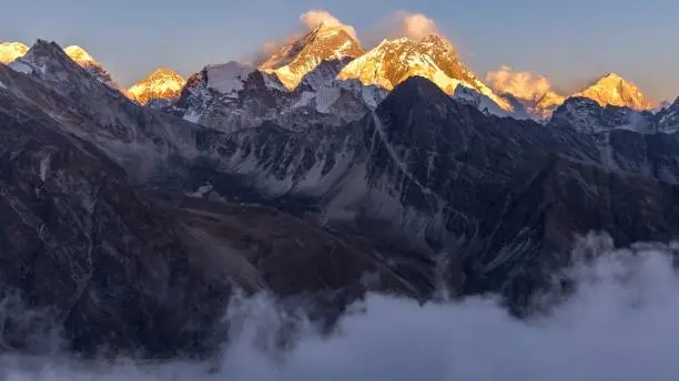 A breathtaking shot of Everest mountain covered in snow from Gokyo Ri, Nepal. Perfect for a wallpaper or a background.