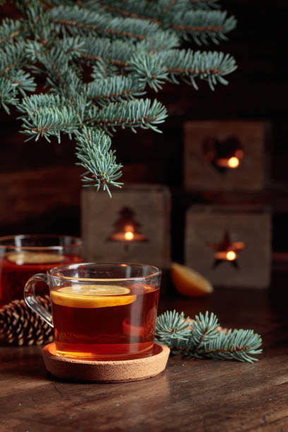 istock Tea with lemon and small Christmas lanterns on a wooden table. 1440290038