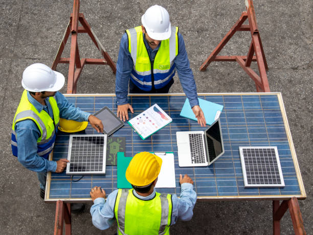 istock Foreman teamwork discussing the plan with solar photovoltaic panels at the workplace 1440290771