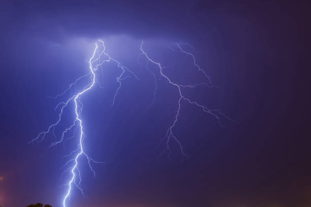 istock Mighty lightning strike in the purple shaded sky 1440290859