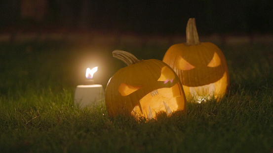 2 Jack O'Lanterns on Grass - Carved Pumpkins - Scary Halloween Decorations - Lanterns - Candles 
On Grass