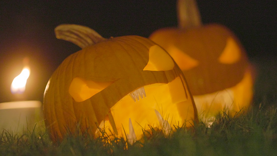 2 Jack O'Lanterns on Grass - Carved Pumpkins - Scary Halloween Decorations - Lanterns - Candles 
On Grass