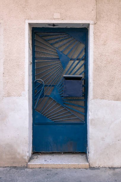 istock Front door with glass, metal grates and mailbox 1440292104