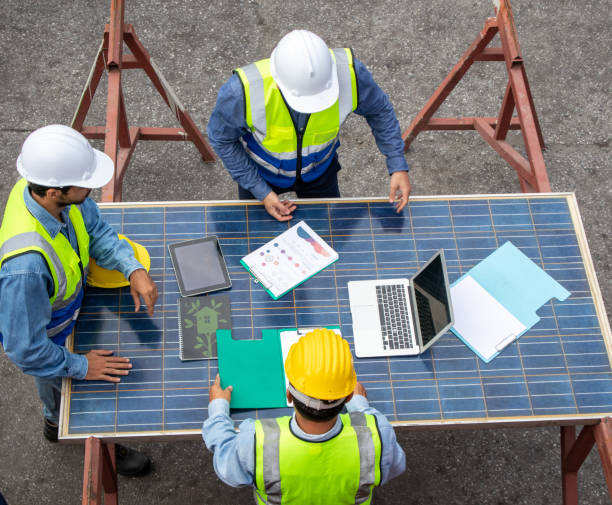 istock Foreman teamwork discussing with solar photovoltaic panels at the workplac 1440292522