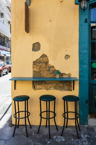 Small counter table and high bar stools at street cafe