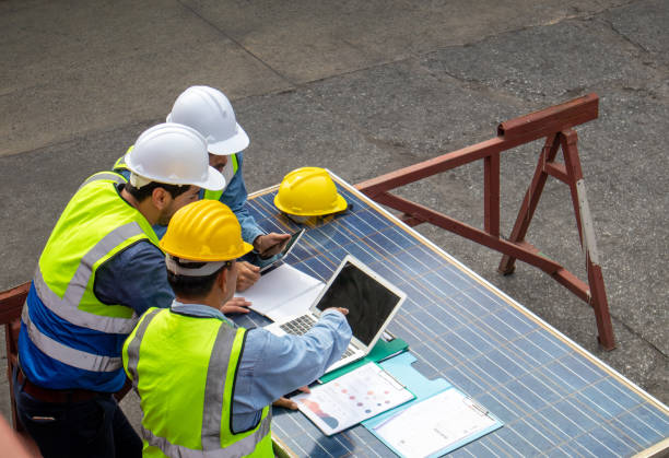 istock Brainstorming communications of technician professional team in safety helmets and uniforms with solar photovoltaic panel 1440292591