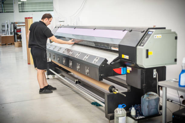 istock Experienced operator works on a UV printer in printing house 1440293466