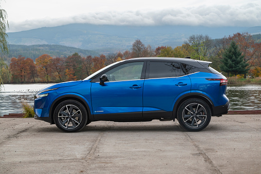 Zdiar, Slovakia - 24th October, 2022: Nissan Qashqai ePower on a road in autumn scenery. The Qashqai is one of the most popular SUV/crossover on European market.