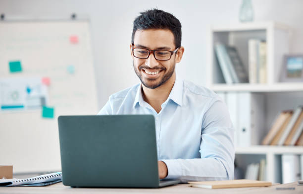 istock Laptop, design and marketing with a creative business man and nerd working on a computer in his office. Email, internet and creativity with a male employee at work in his modern advertising agency 1440297403