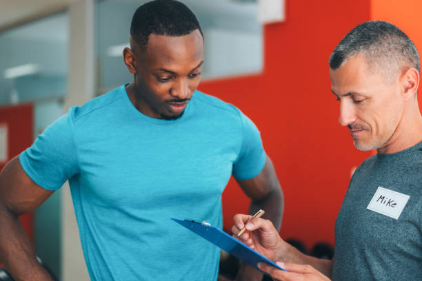 istock Sports training in the gym with personal trainer 1440299761