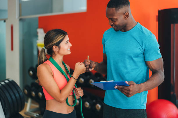 istock Sports training in the gym with personal trainer 1440299969