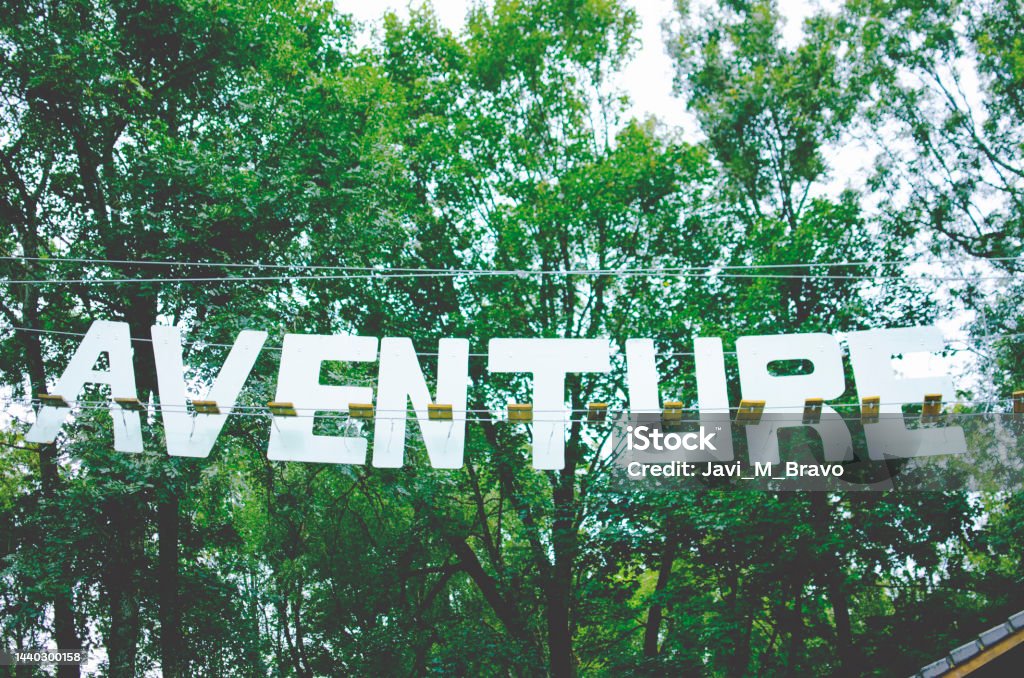 adventure letters hanging in a forest Adventure Stock Photo