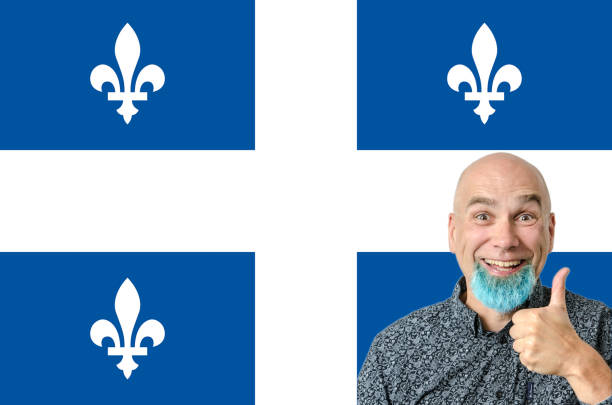 Bald mature proud man with blue dyed beard in front of Quebec flag