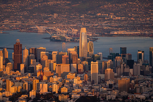 Aerial view of downtown city with Yerba Buena Island in background during sunset, San Francisco, USA.