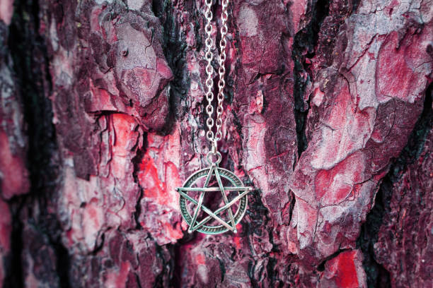 istock Pentagram necklace against a red tree bark 1440305108