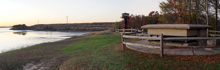 Fort Mott waterfront on the left bank of Delaware River, observation post of Battery Arnold and fire control tower, panoramic view at sunset, Pennsville Township, NJ, USA