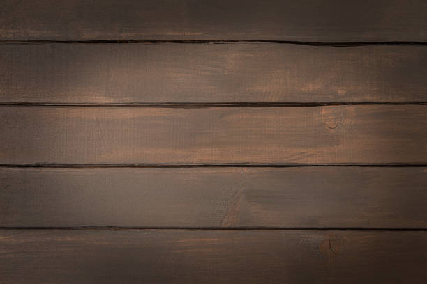 istock Textured dark wooden table, abstract background, empty template, top view. 1440310213
