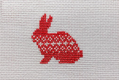 The symbol of 2023 is a rabbit embroidered with red threads on a white cloth.