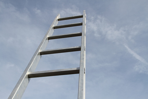 A man is trying to get up the ladder