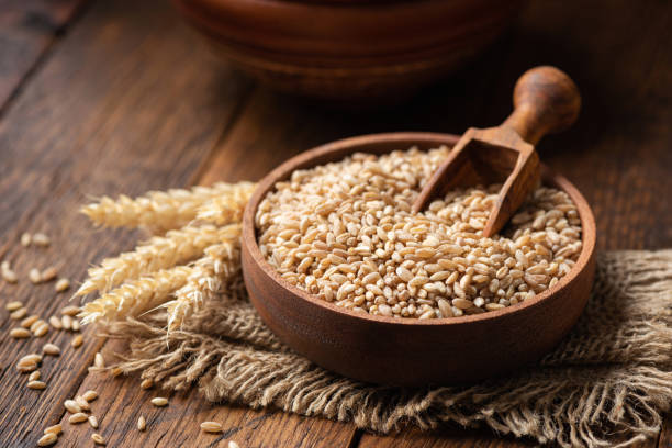 Whole wheat, spelt grains in a wooden bowl